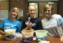 Abby Haubrich, Alison Peymann, and Laurel Duncan serve ce cream at recruiting event