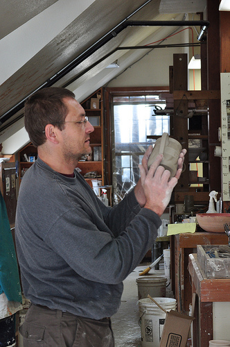 Dave Greenlund works on a ceramic cup