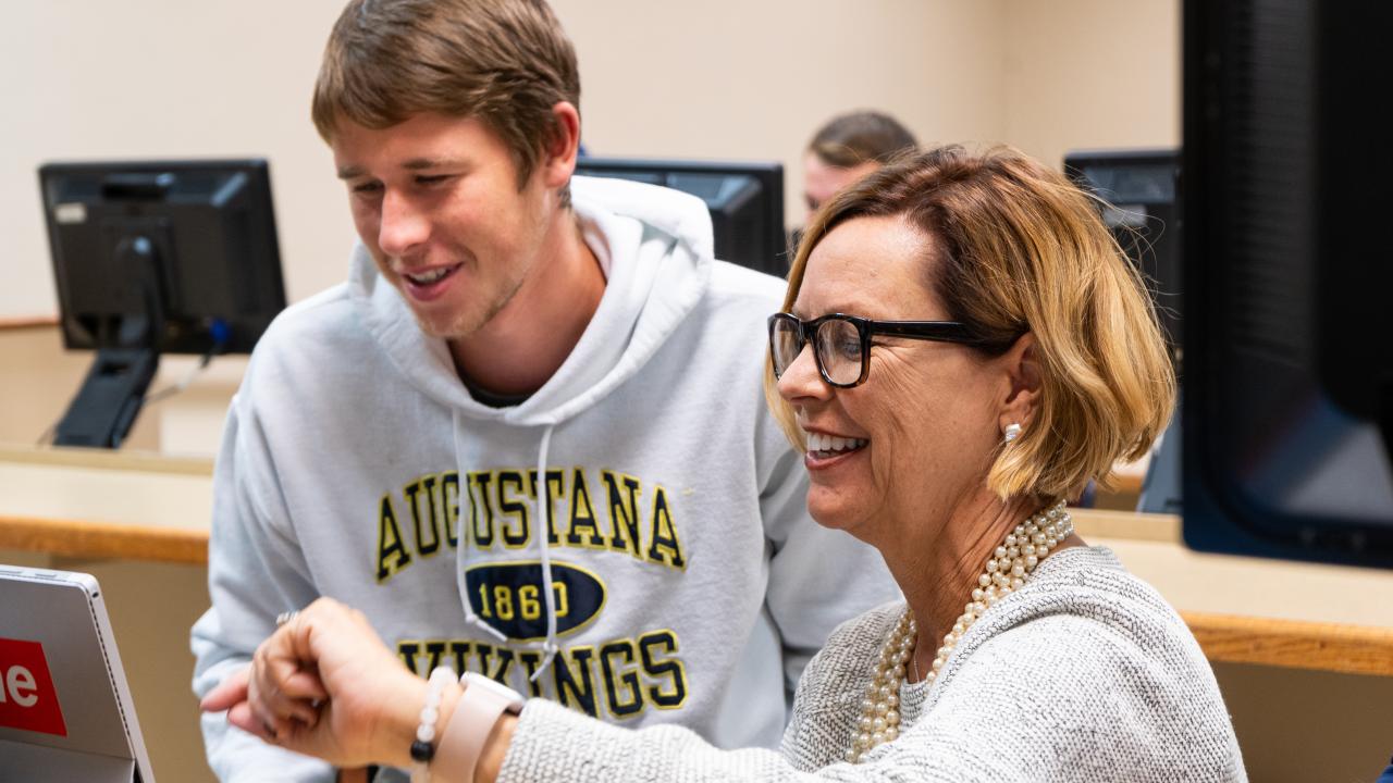 Professor showing student something on computer
