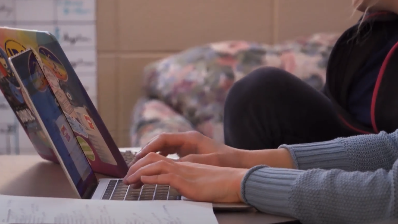 students typing on computer