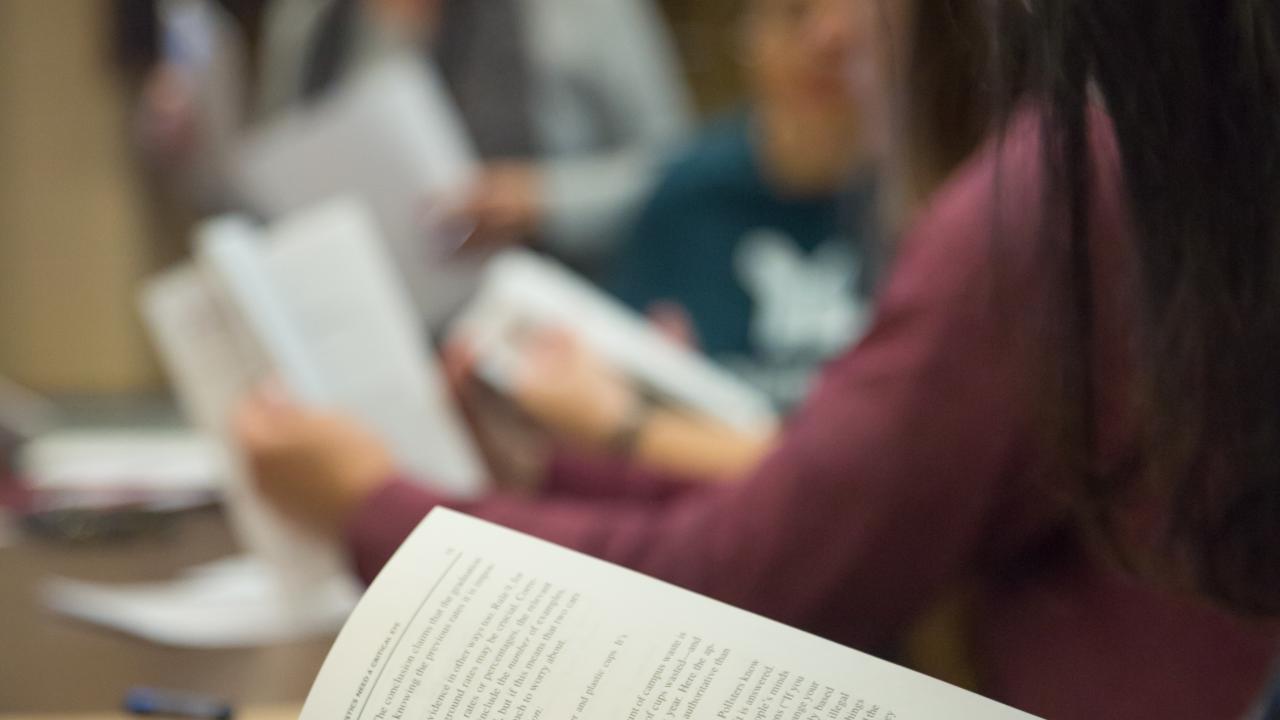 student reading in a book