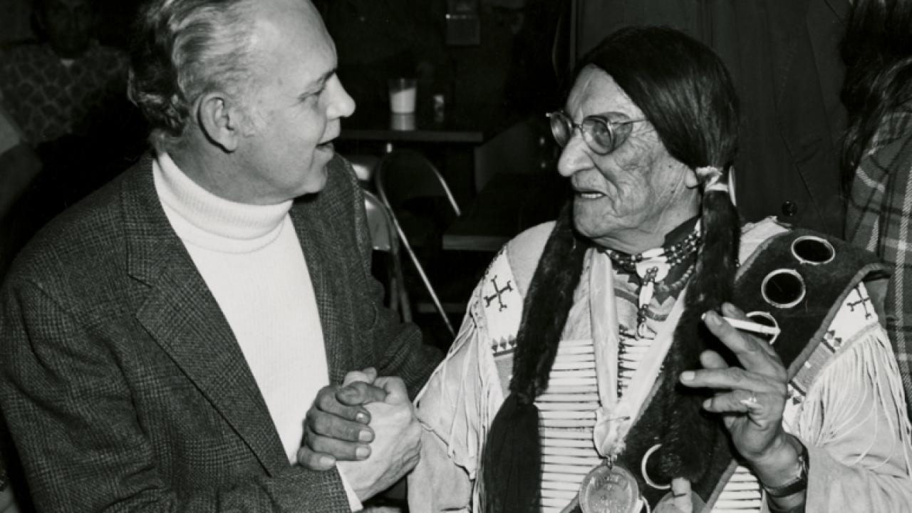Pastor Paul Boe speaks with Chief Frank Fools Crow. A nephew of Oglala Lakota holy man Black Elk, Fools Crow worked to help preserve Lakota traditions. Both men supported the American Indian Movement, and both were present at the 1973 occupation of Wounded Knee.