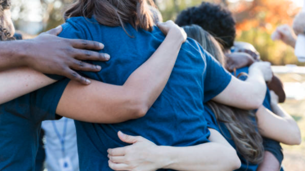 Students hugging in a circle