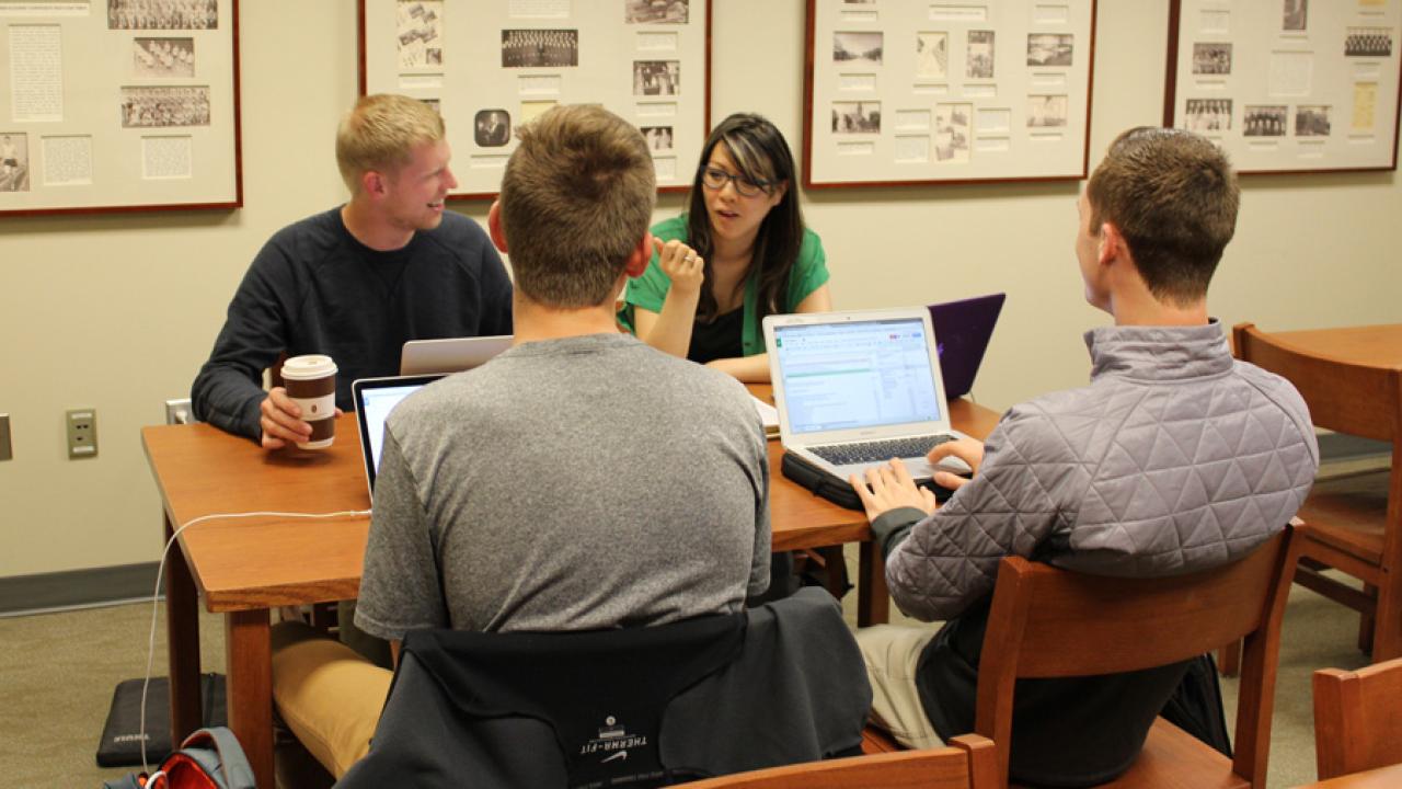 Professor Carolyn Ly-Donovan discusses research strategies with students.