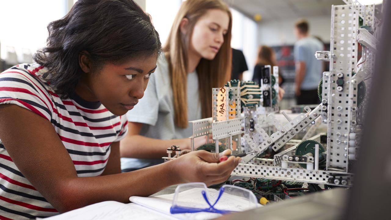 Girl working with robotics set