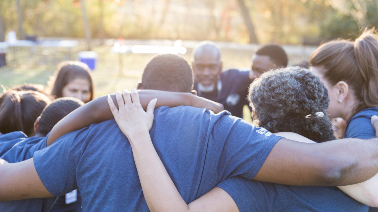 group with arms around each other