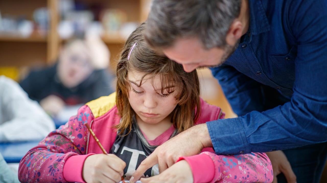 teacher working with student