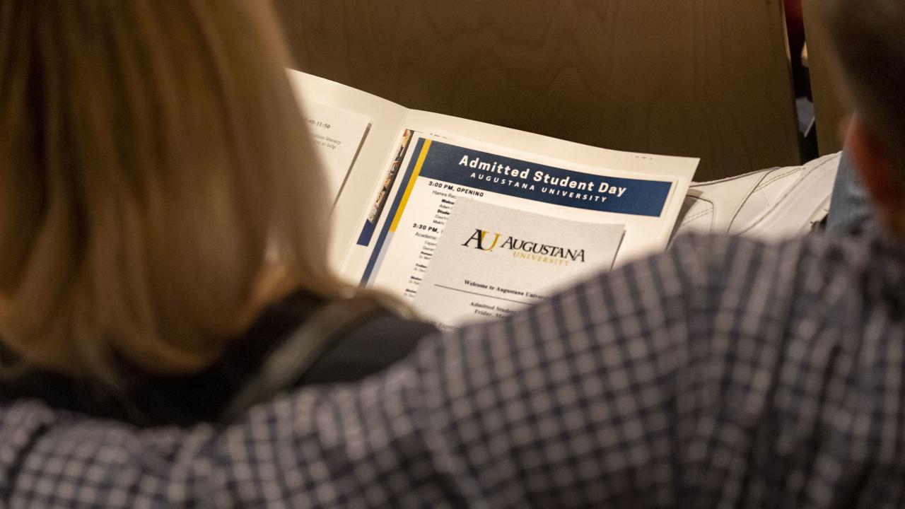 Parents looking at a folder of materials