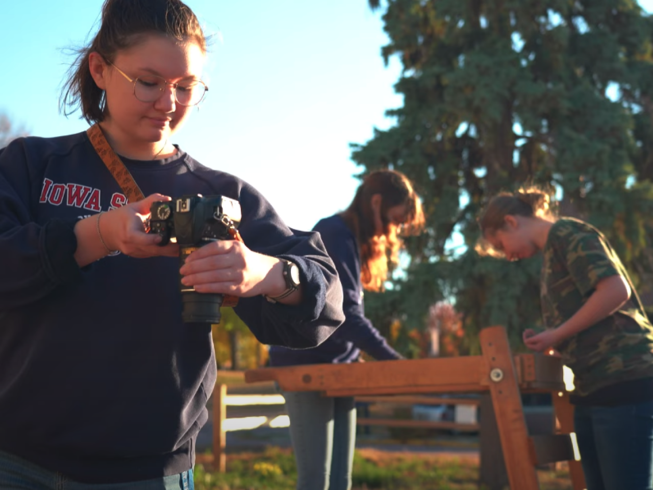 student taking photo of dig site