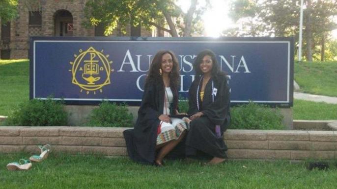 Meti and Hilina in front of Augustana College Sign
