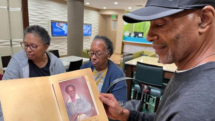 Alfred White Jr. Holds Picture of Father
